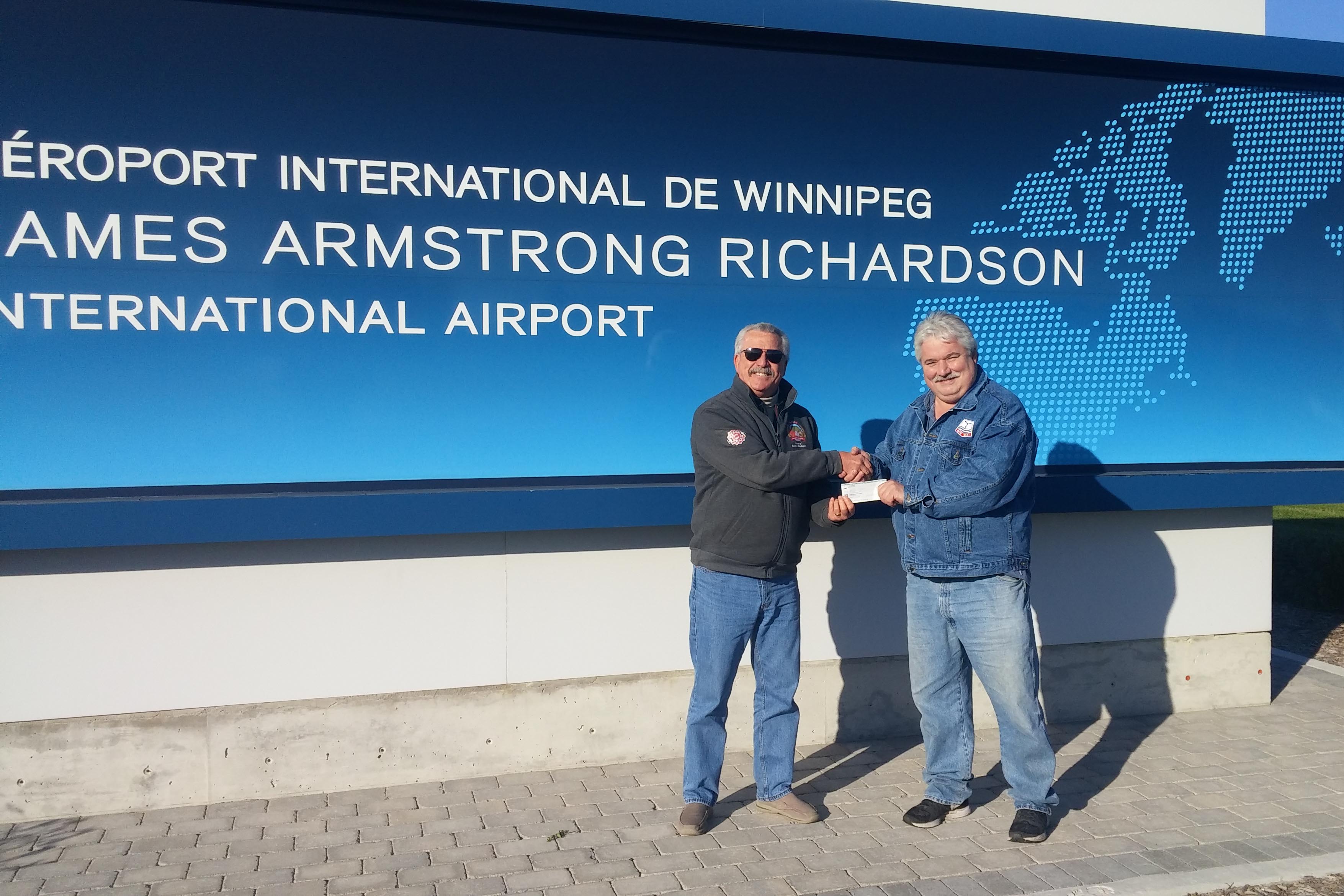 Wayne Barbeau presenting the cheque to Jacques Legare
