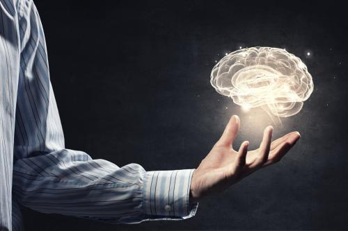 glowing brain above someone's hand